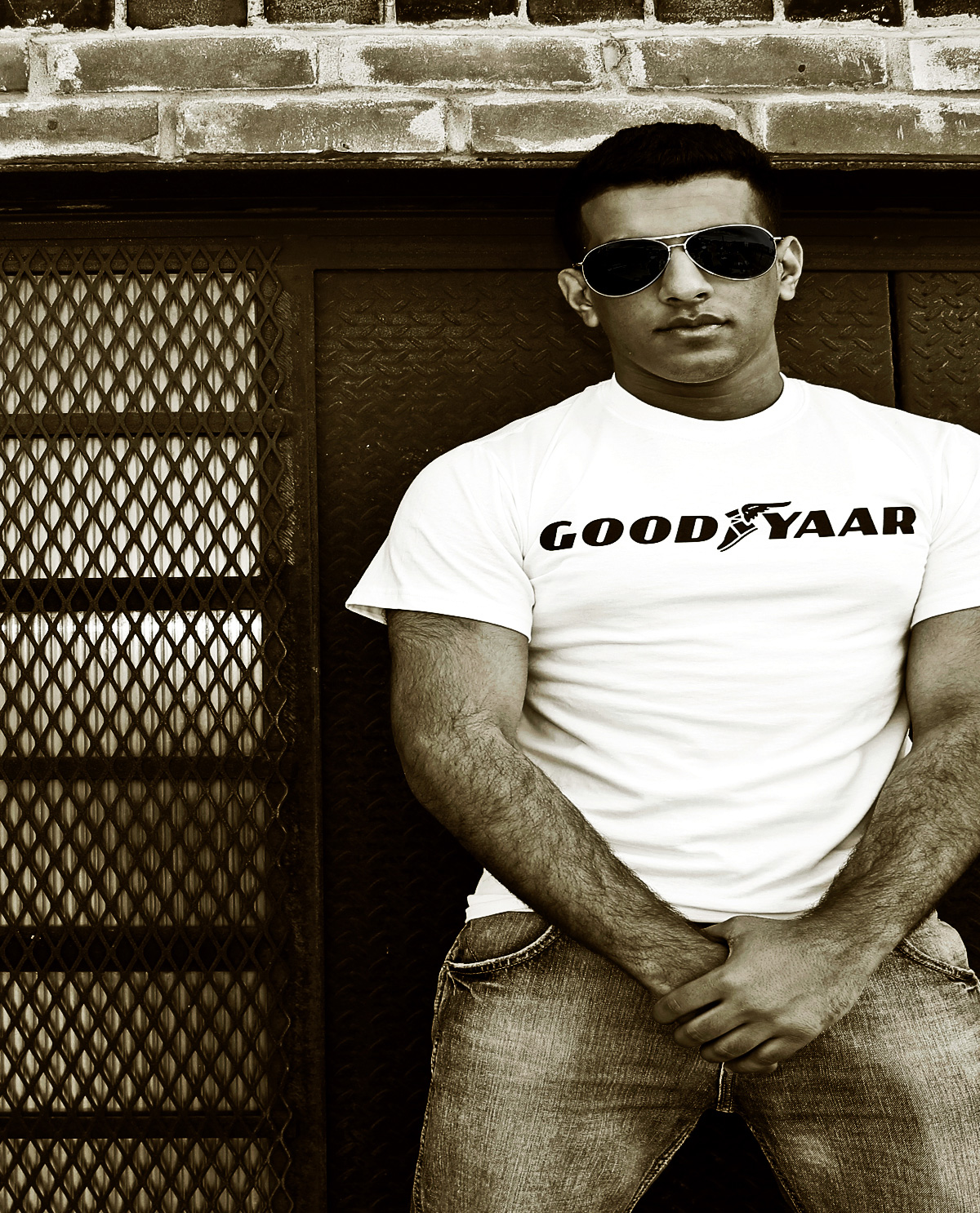 South Asian male model wearing white t.shirt with Graphic Design letter on front that says Good Yaar.  South Asian Desi Themed Graphic Design t.shirts by Brown Man Clothing Co.