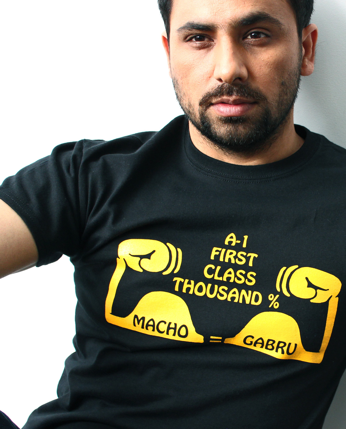 Macho Grabru graphic design t.shirt being worn by South Asian male model. South Asian Desi Themed Graphic Design t.shirts by Brown Man Clothing Co.