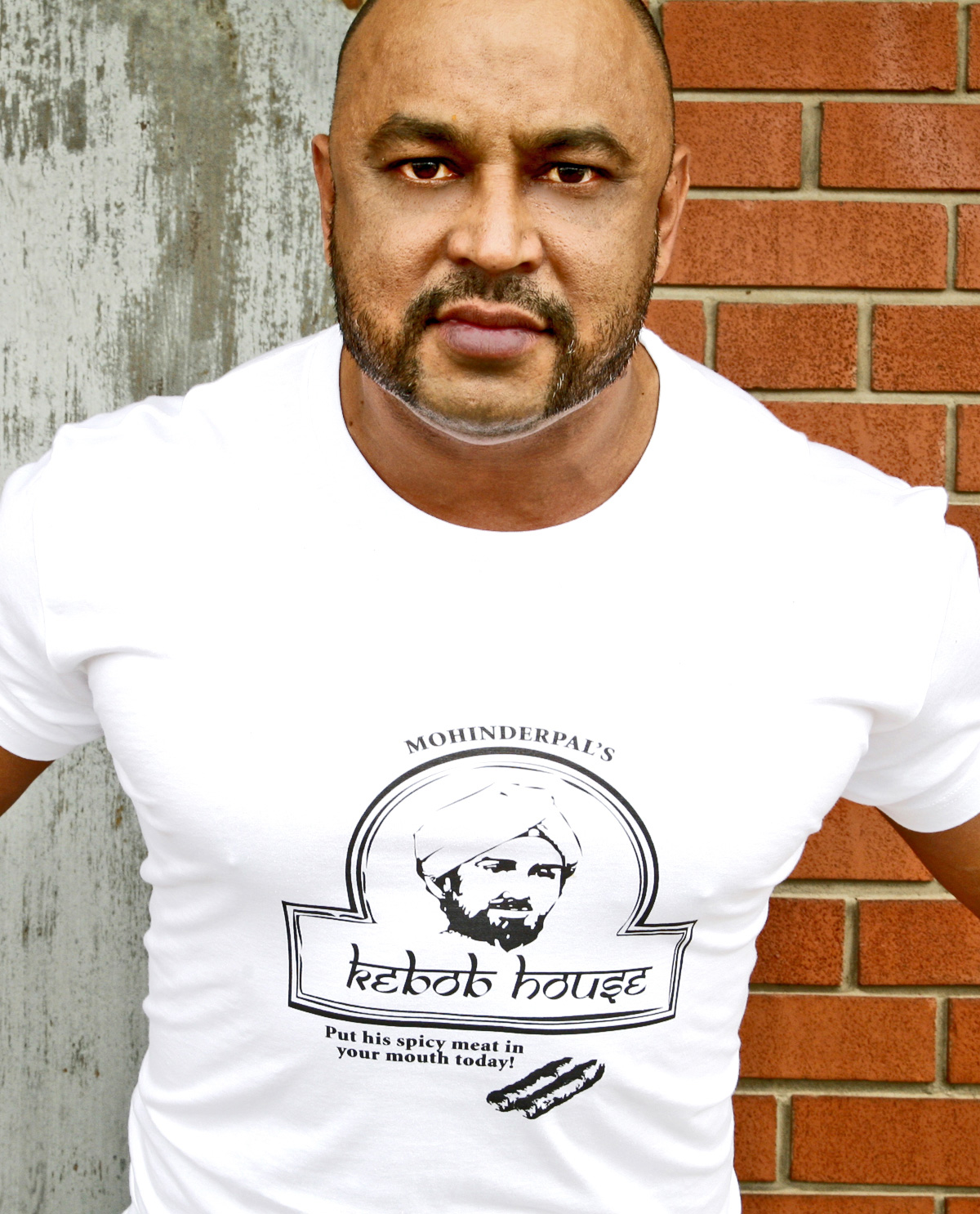 South Asian Male Model White Tshirt with Graphic Design on front of Mohinderpal's Kebob House. Graphic design t.shirts by Brown Man Clothing Co.