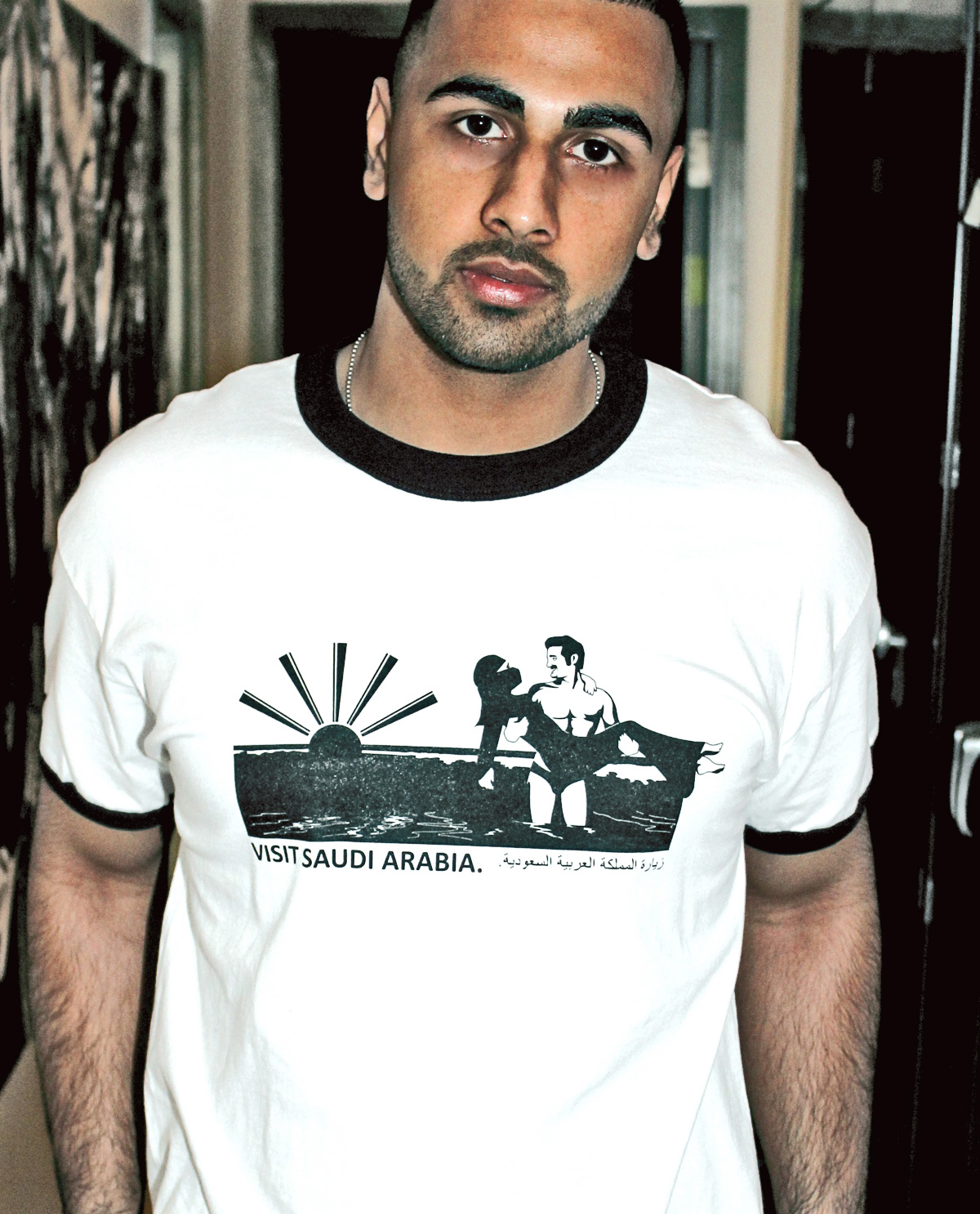 Visit Saudi Arabia Graphic Design T.shirt printed on white and black ringer t.shirt by Brown Man Clothing Co.